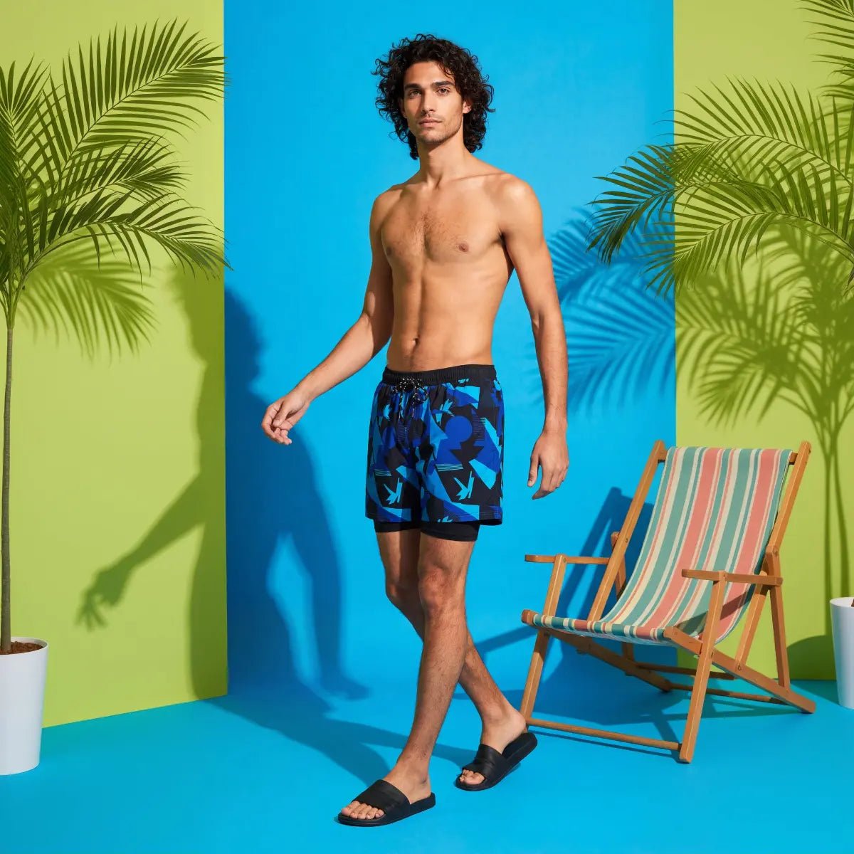 Ocean Drift Blue Swim Shorts styled in a tropical setting