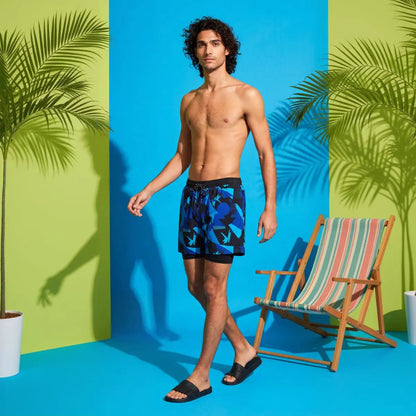 Ocean Drift Blue Swim Shorts styled in a tropical setting